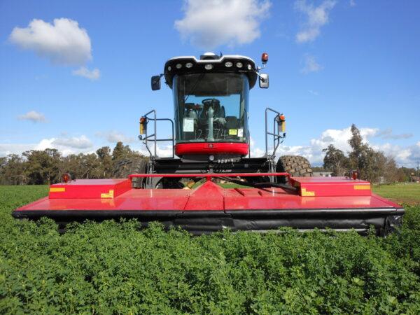 Self-Propelled Mower Conditioner and Operator - Image 3